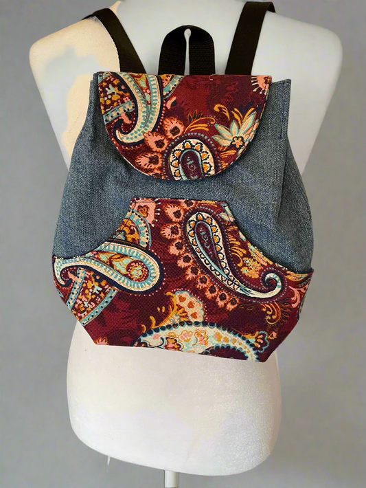 Small adult backpack made from reclaimed denim and cotton berry colored paisley accents.